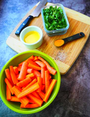 Ingredients for Roasted Carrots with Turmeric side dish on a cutting board