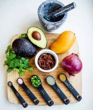 Ingredients for Mango Guacamole displayed on cutting board