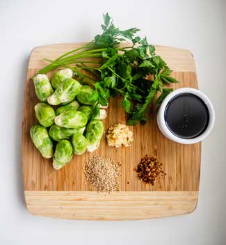 Ingredients for Delish Bang Bang Brussels displayed on a cutting board