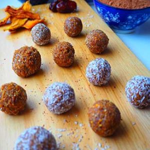 apricot-date-energy-balls laid out on a cutting board