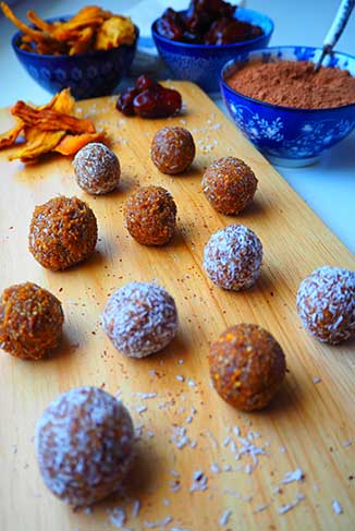 apricot-date-energy-balls laid out on a cutting board
