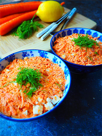 Creamy Shredded Carrot Salad in two bowls garnished with feta cheese and dill