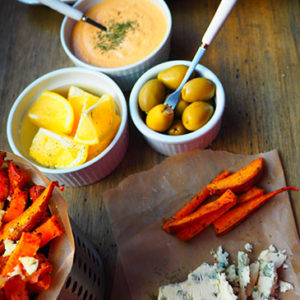 Oven Roasted Sweet Potatoes on a table alongside condiments