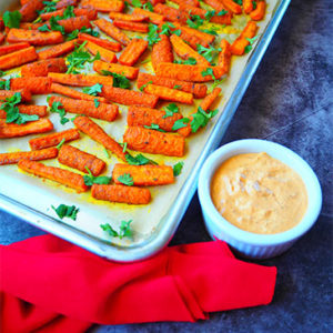 Roasted Carrots with Turmeric alongside dipping sauce