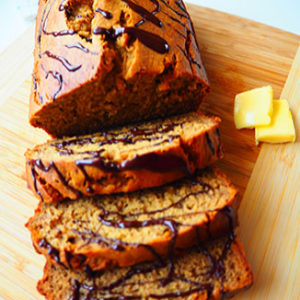 Almond-butter-pumpkin-bread sliced on a cutting board