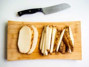 Potatoes-sliced-into-frites on a cutting board