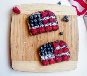 American Flag Chocolate Toast decorated with berries on a cutting board