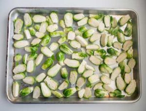 Halved Brussels Sprouts on a baking sheet ready for roasting